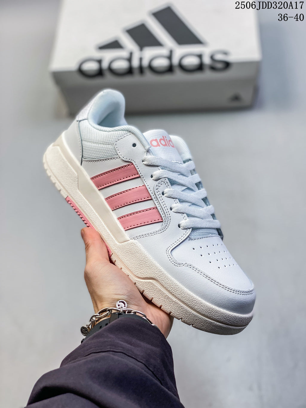 Angled side view of a white adidas Entrap sneaker with pink stripes