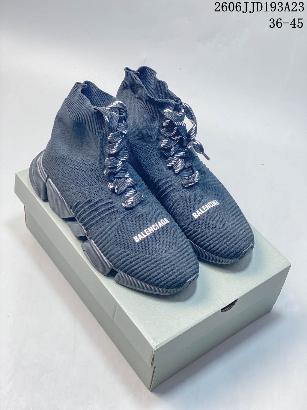 Pair of navy Balenciaga sock-style sneakers with contrast laces and chunky segmented soles