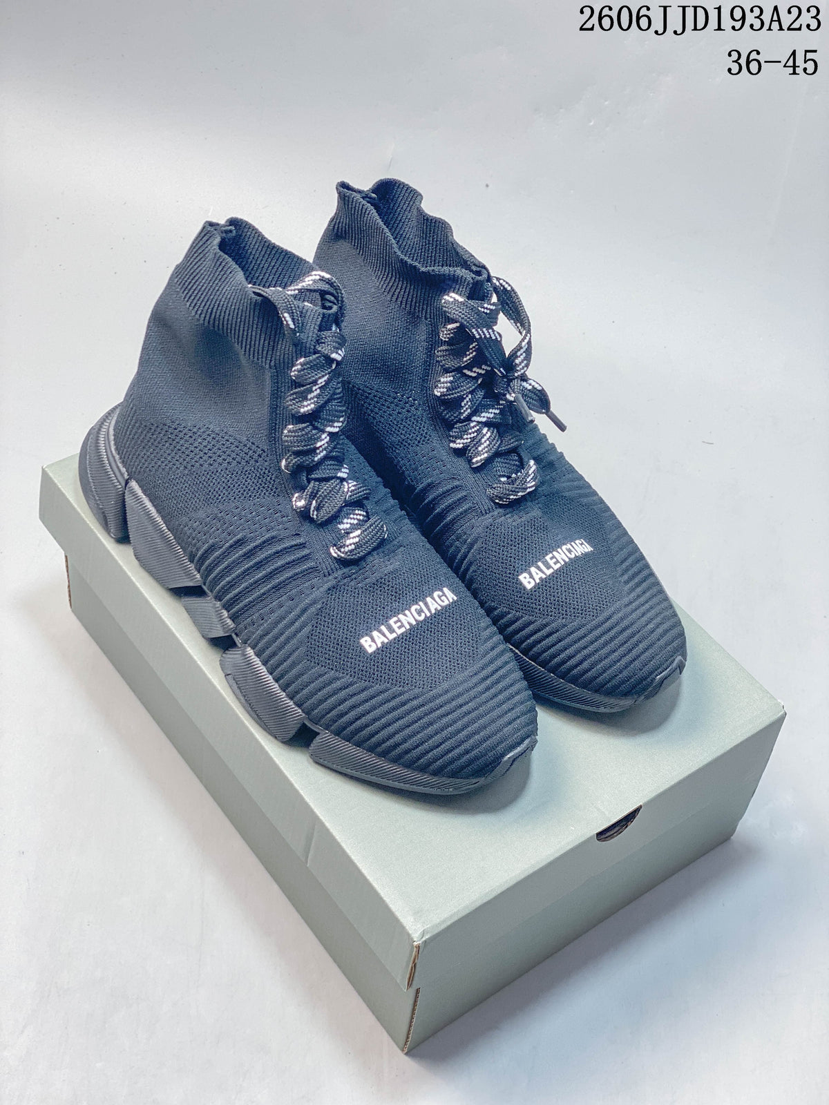 Pair of navy Balenciaga sock-style sneakers with contrast laces and chunky segmented soles