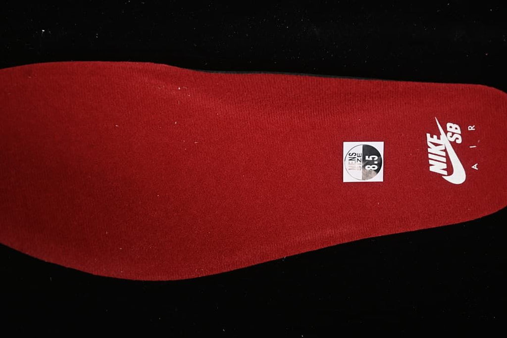 Red insole with Nike SB branding and a visible sample size marking