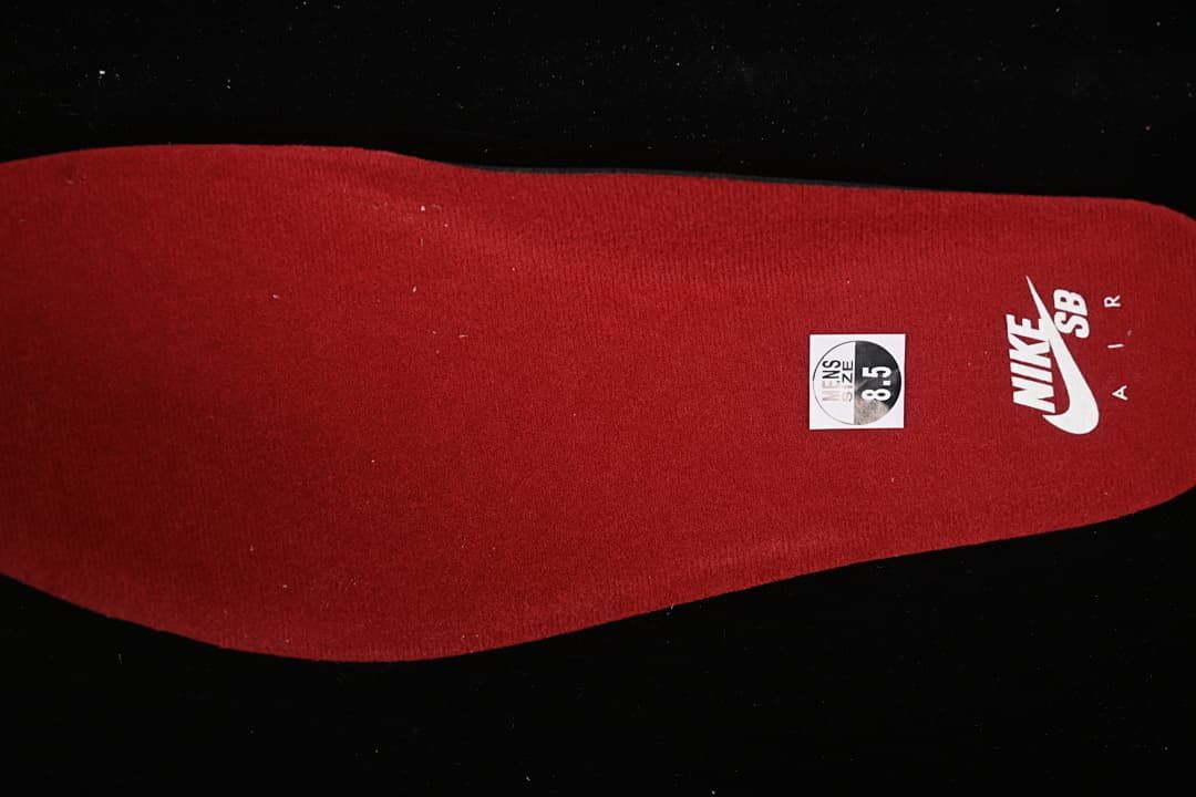 Red insole with Nike SB branding and a visible sample size marking