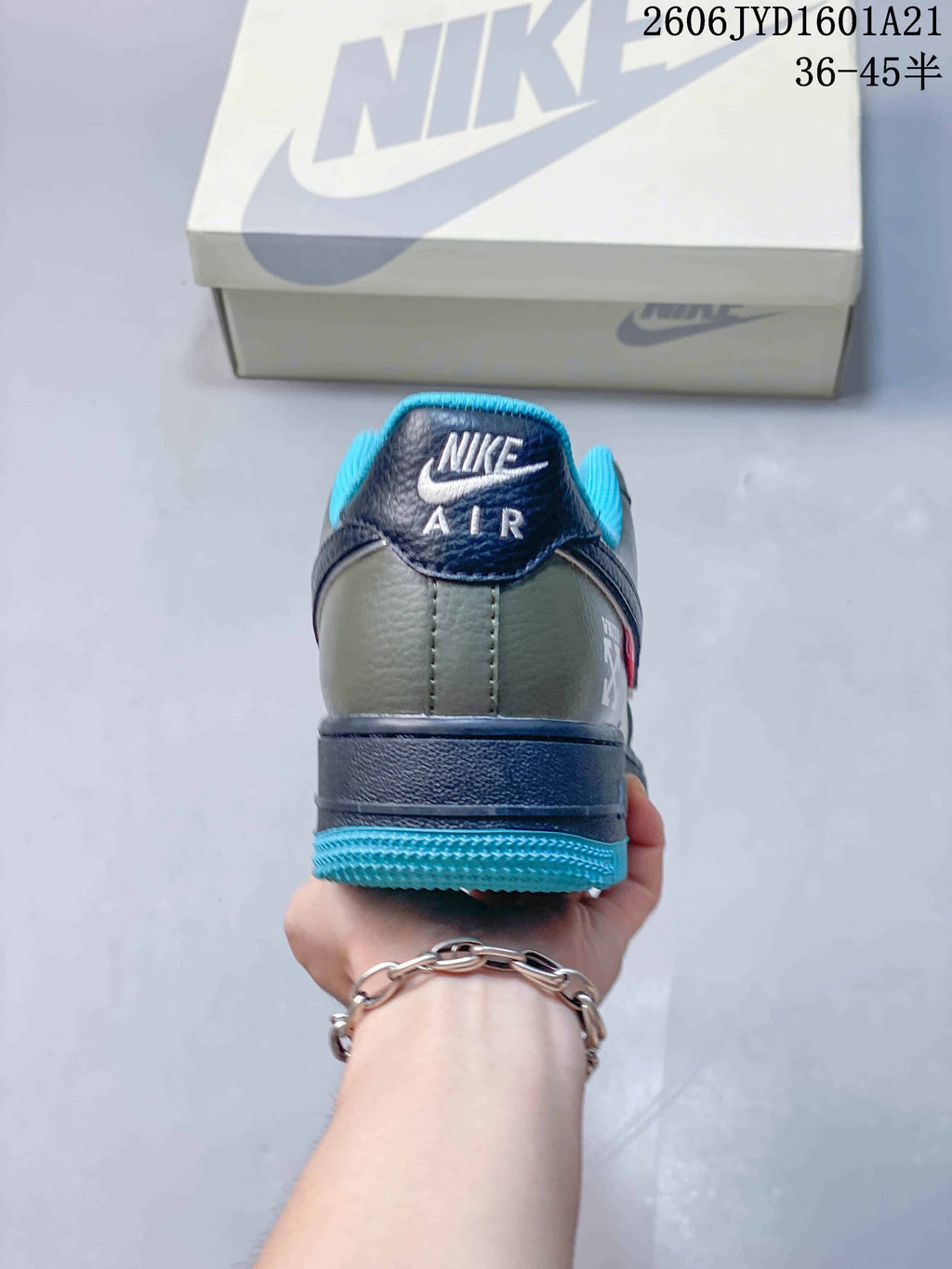 Rear view showing a navy heel tab and bright blue collar and outsole.