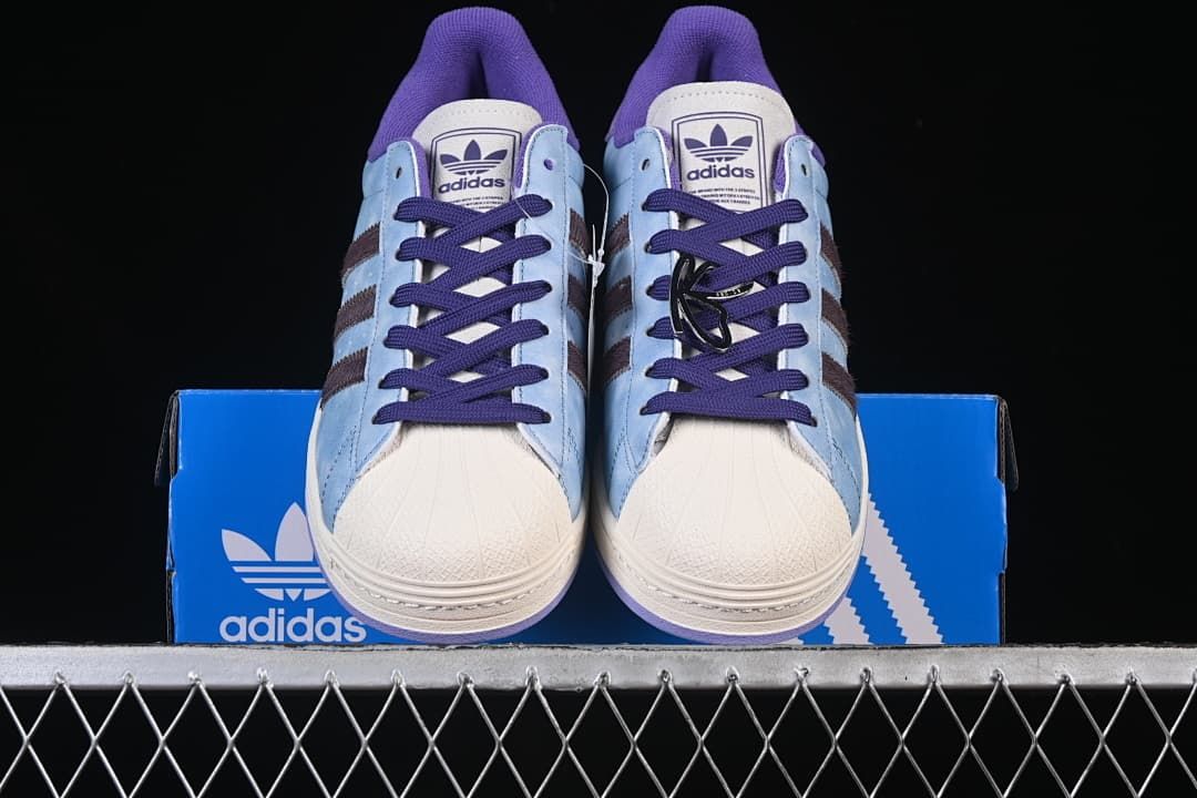 Front view of the pair showing shell toes, laces and purple accents