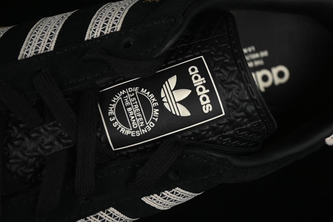 Close-up of the sneaker tongue label and black laces.
