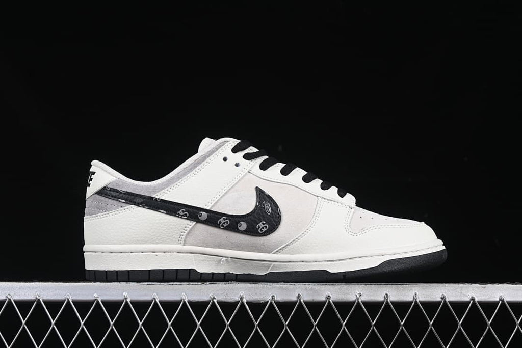 Side profile showing the white and gray upper, patterned black Swoosh, and black outsole