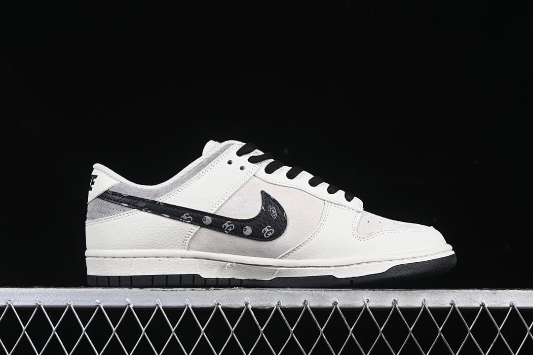 Side profile showing the white and gray upper, patterned black Swoosh, and black outsole