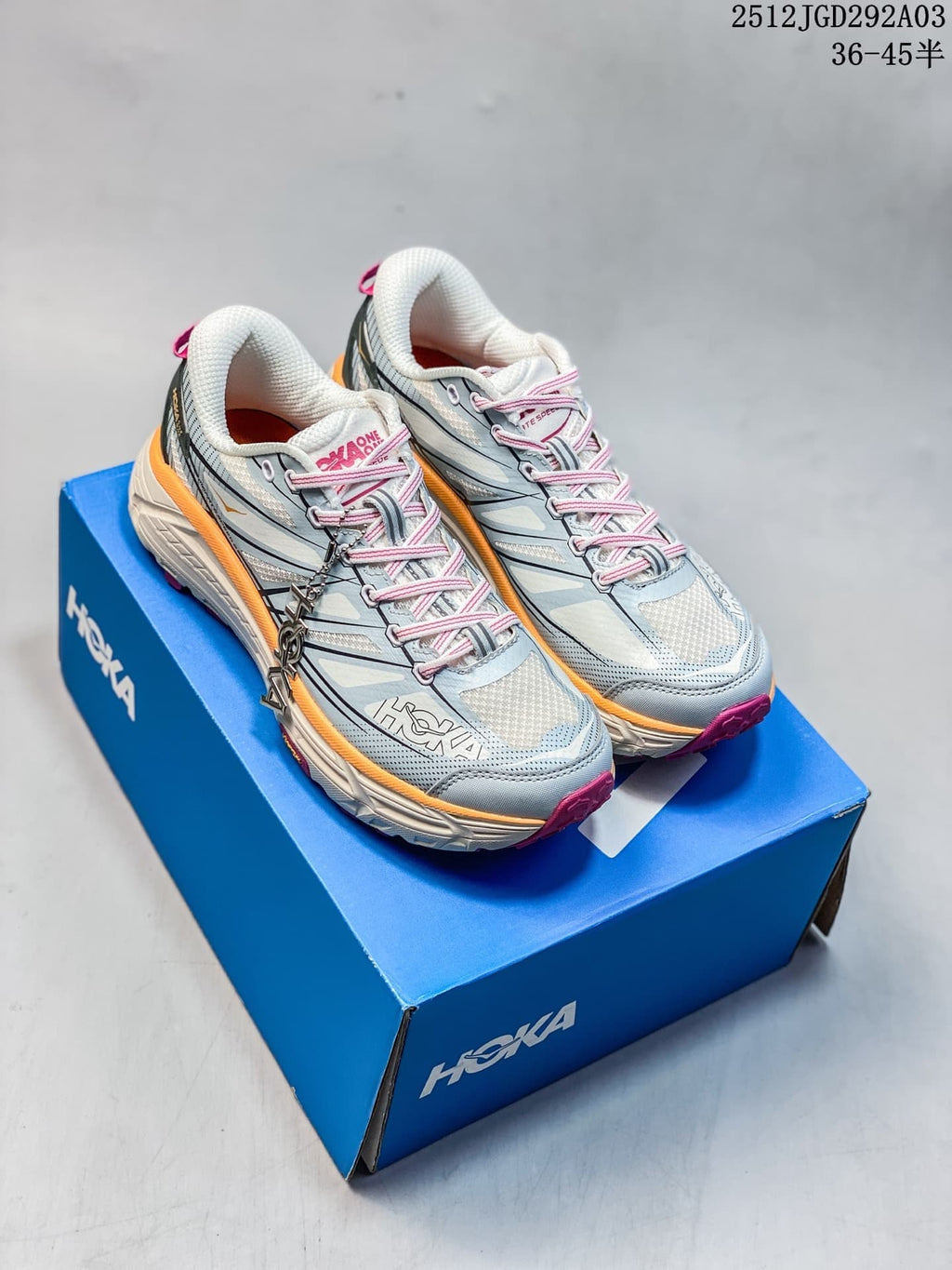 Pair of light blue HOKA Mafate Speed 2 trail shoes with pink and orange accents.