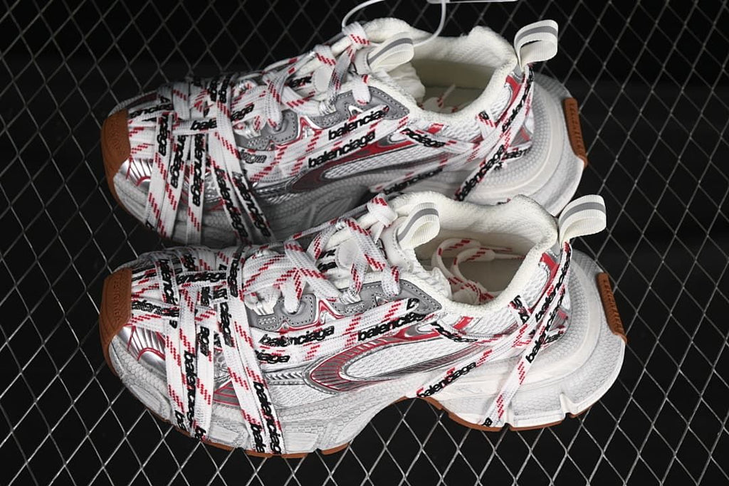 Pair of white, red, and gray 3XL sneakers with brown-toned outsole details