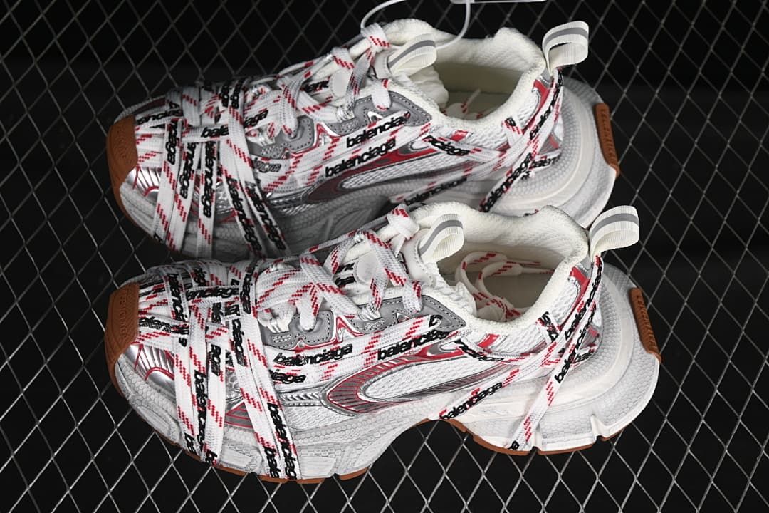 Pair of white, red, and gray 3XL sneakers with brown-toned outsole details