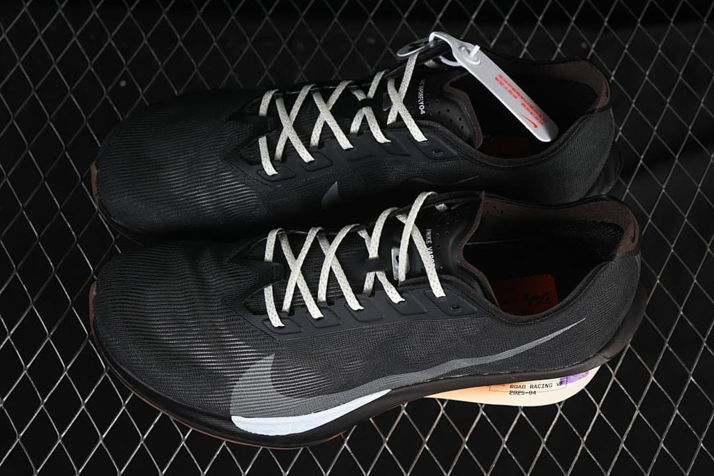 Pair of dark road racing shoes shown from above at an angle.