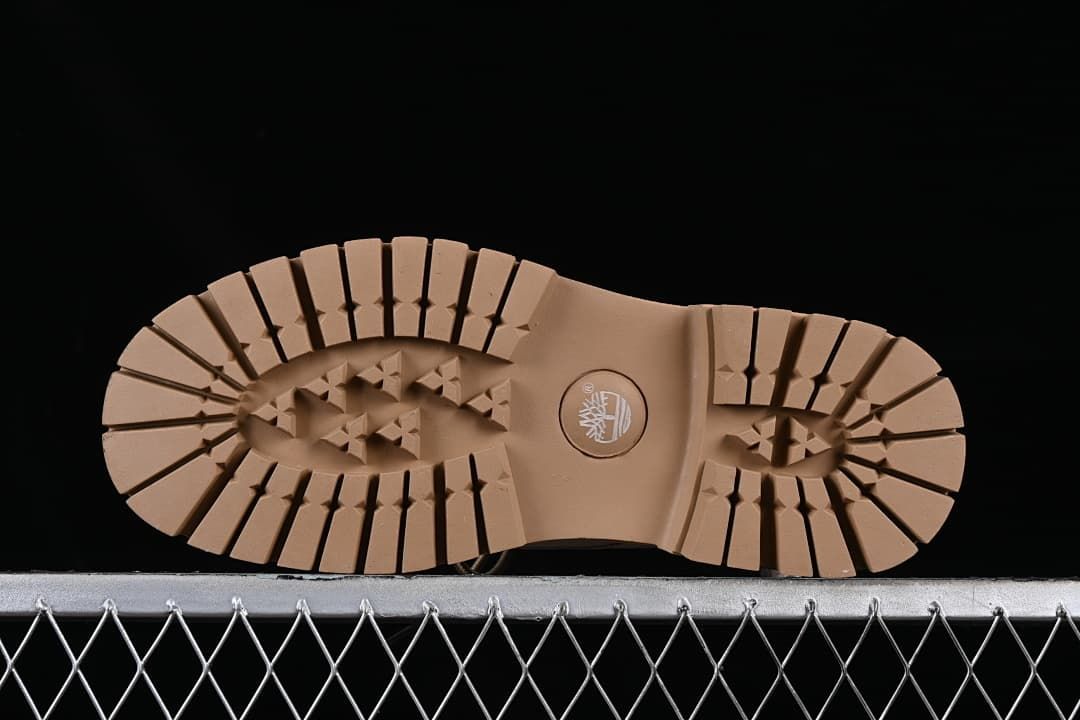 Underside view of the tan outsole with segmented tread