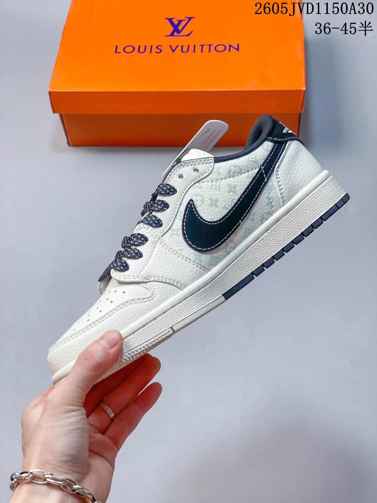 Side profile of the low-top sneaker with a dark side emblem, pale patterned panels, and off-white sole.