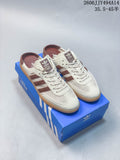 Pair of cream and brown adidas Samba-style mule sneakers with gum-colored soles.
