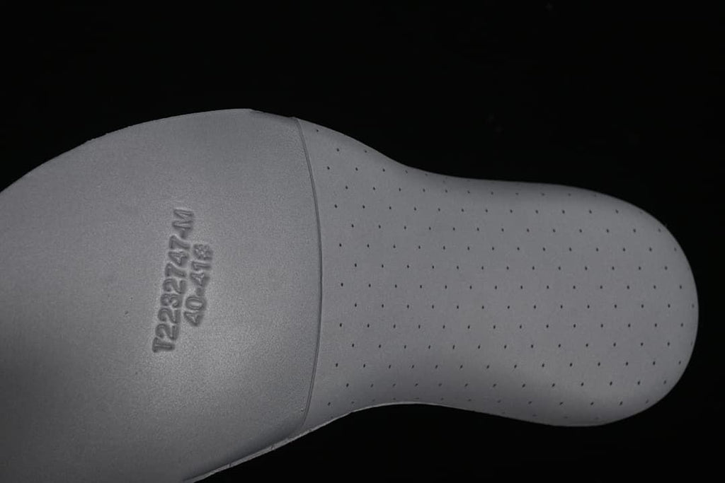 Close-up of the perforated gray insole with embossed markings