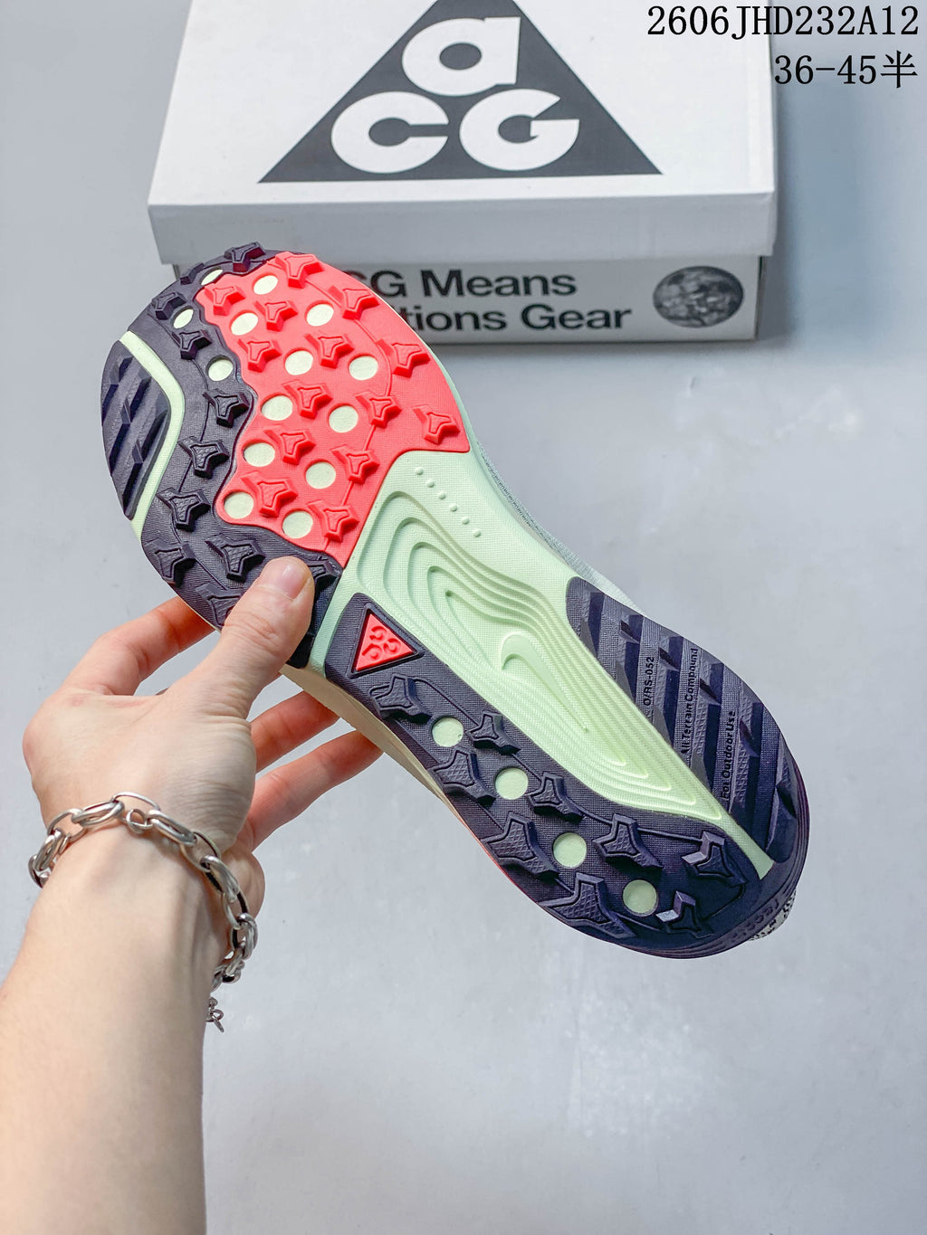 Underside of the Nike ACG Pegasus Trail shoe showing a multicolor lugged outsole.