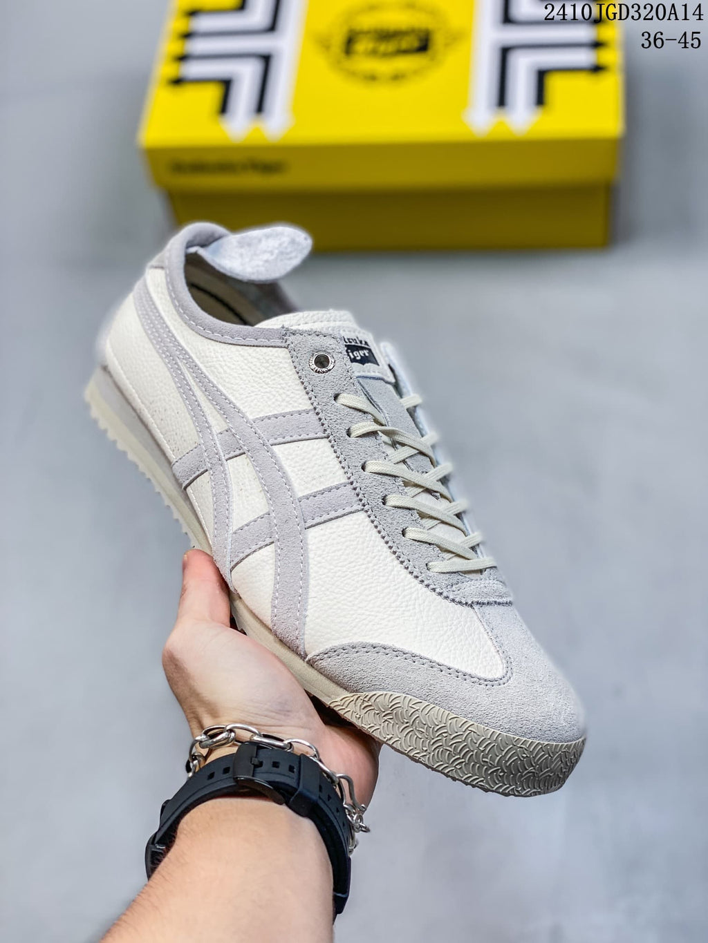White low-top sneaker with light gray side stripes and gray suede-look panels