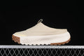 Side profile of a light neutral The North Face slip-on mule sneaker with white midsole and brown tread.