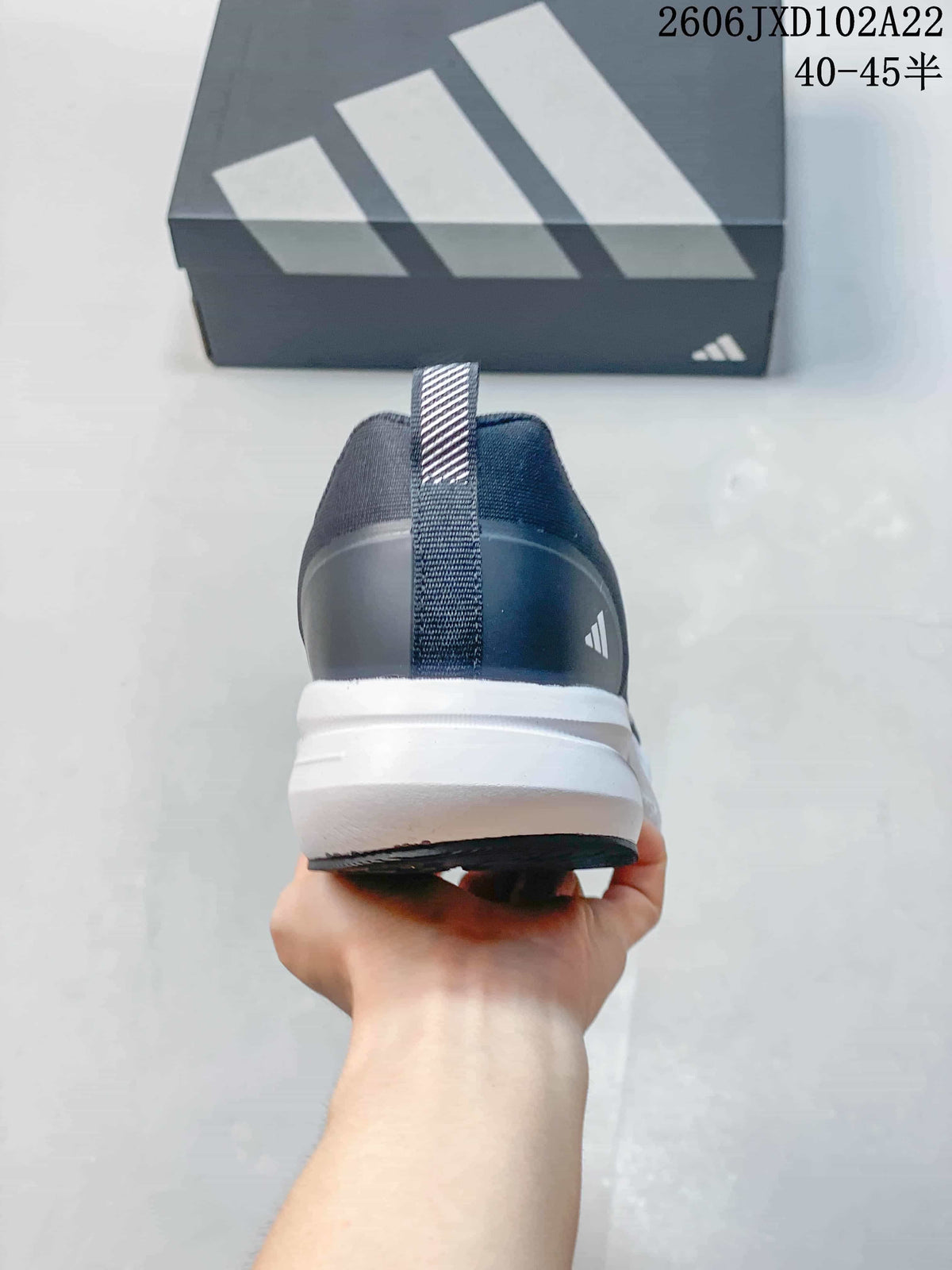 Rear view of a navy sneaker showing the heel pull tab and white midsole.