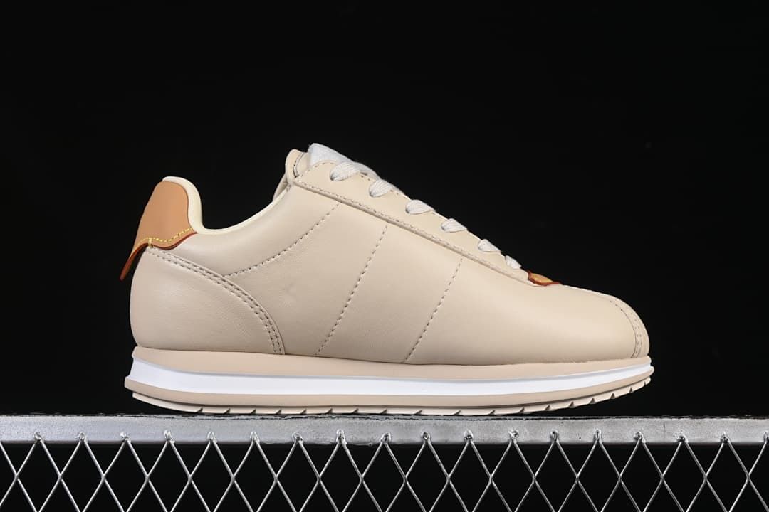 Side profile of beige low-top sneaker