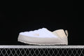 Side view of a white and beige The North Face mule