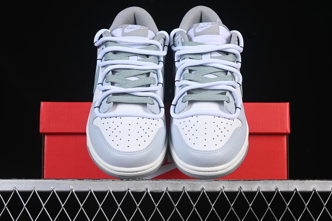 Front view of the sneaker pair on a red box