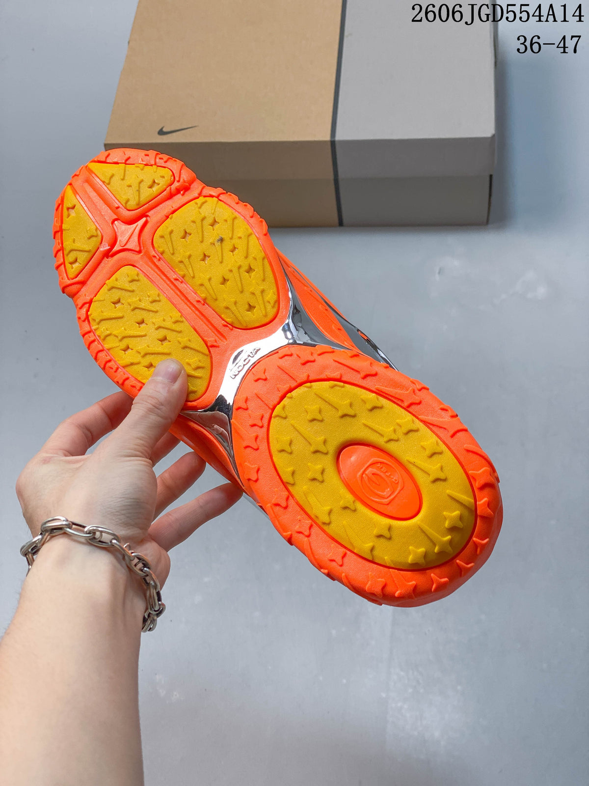Underside of the orange sneaker showing a patterned yellow-and-orange outsole