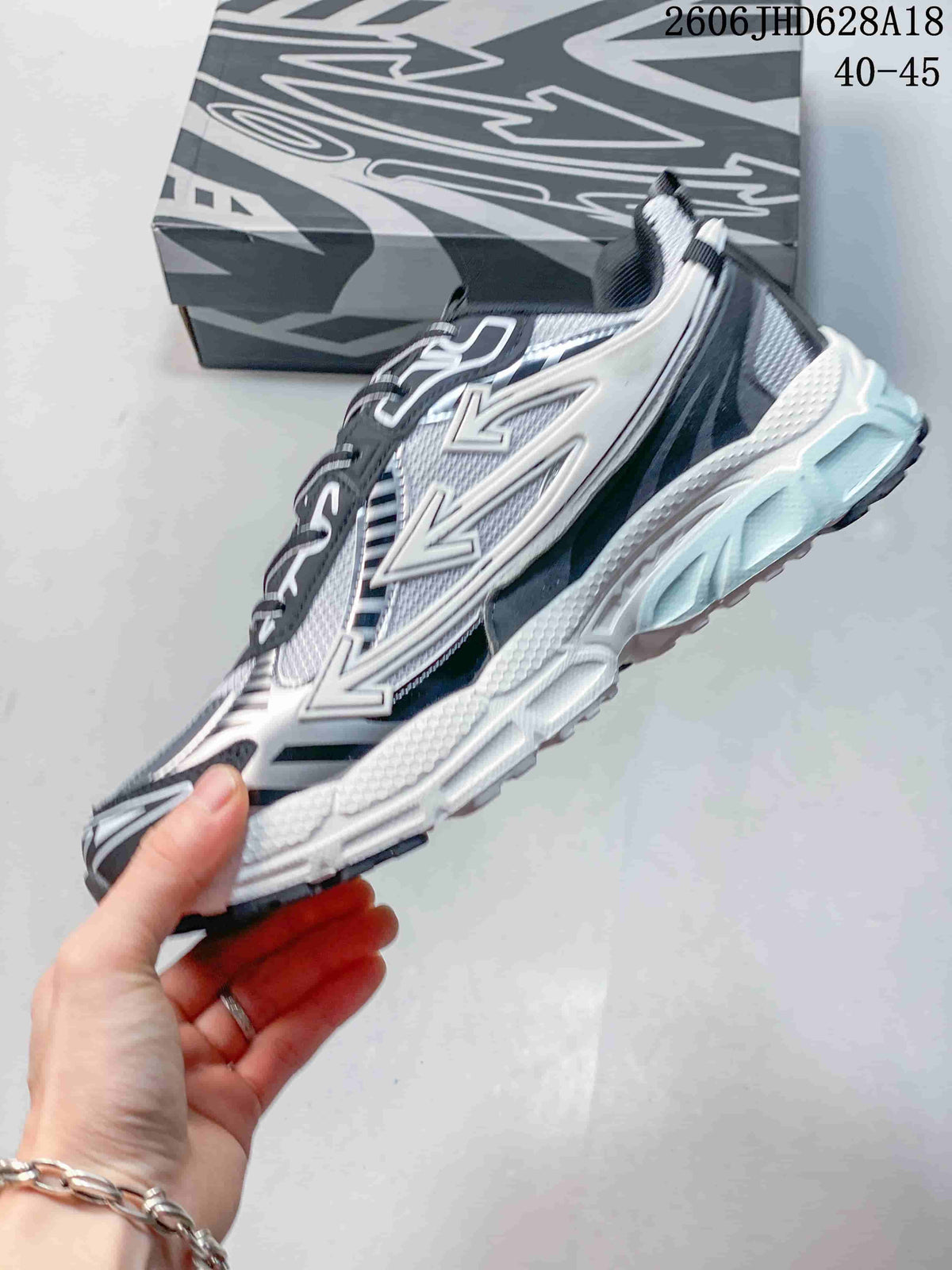 Side profile highlighting the layered upper, graphic details, and thick sole