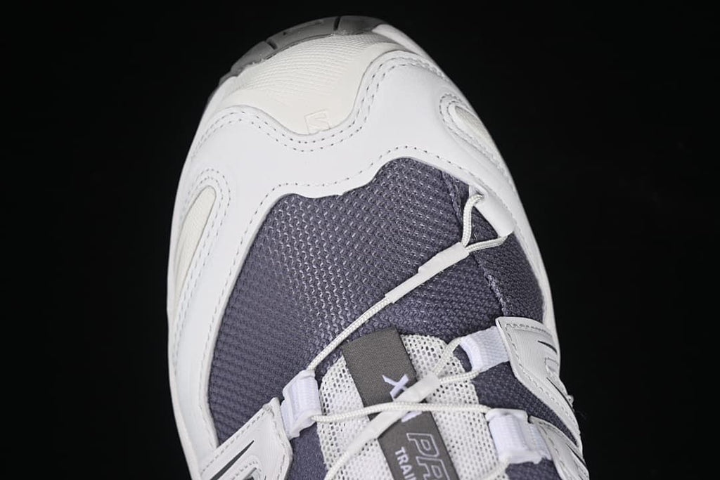 Top-front close-up of the dark mesh toe and cord lacing