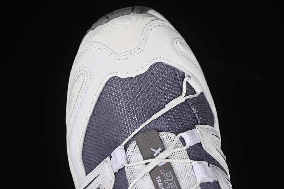 Top-front close-up of the dark mesh toe and cord lacing