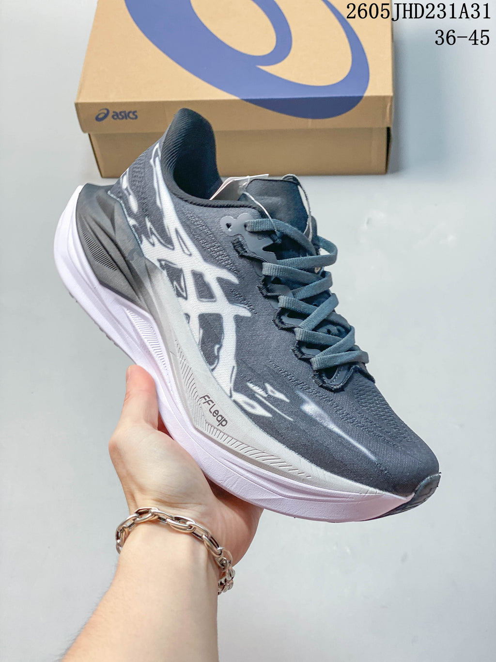 Angled side view of the gray and white ASICS MEGABLAST shoe