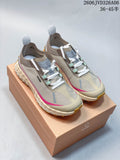 Pair of taupe Norda 001 sneakers with pink accents displayed on a branded box.
