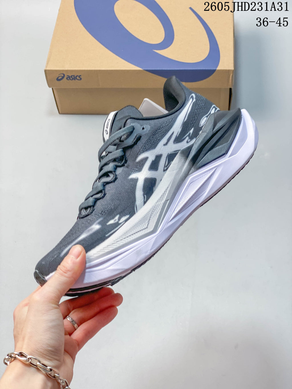 Side profile showing the gray patterned upper and sculpted white sole