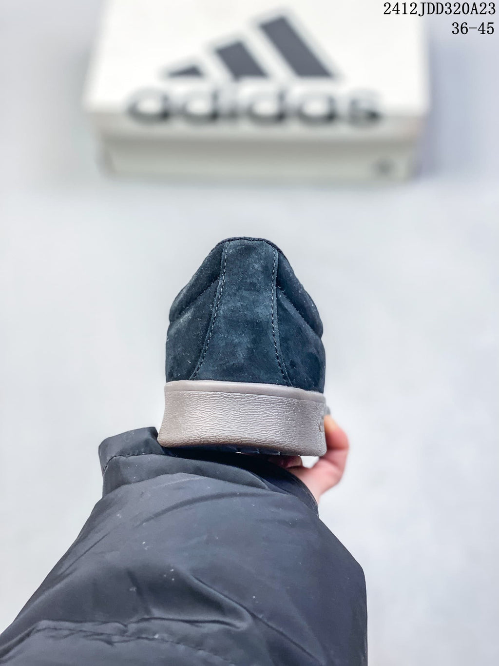 Rear view of a black Adidas VL Court Classic sneaker with a gray sole