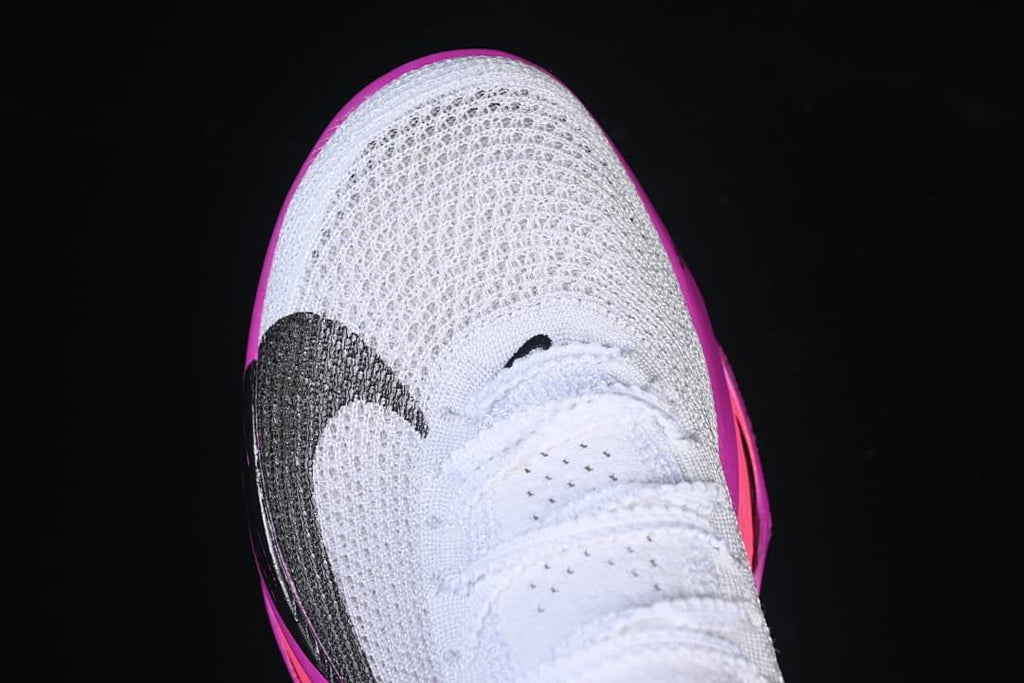 Top view of the white mesh-look toe and laces with a dark Swoosh detail.