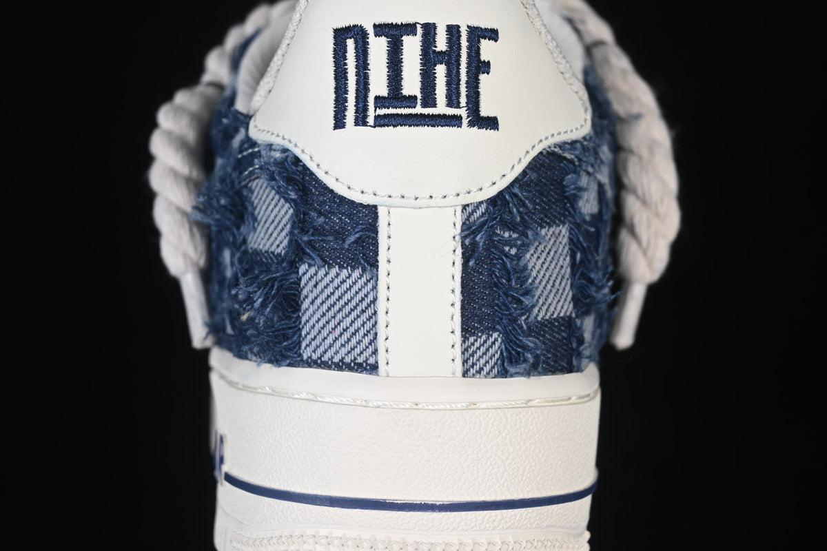 Heel detail showing distressed blue panels, off-white tab, and sidewall stripe