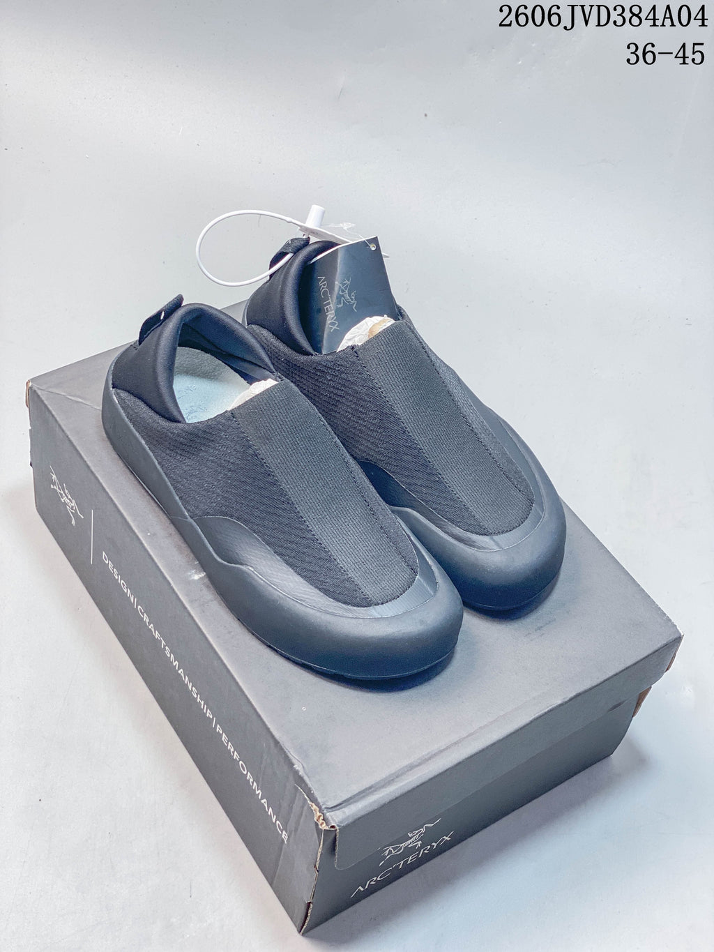 Dark charcoal Arc'teryx Kragg-style slip-on shoes on a branded box; image label shows 36–45.