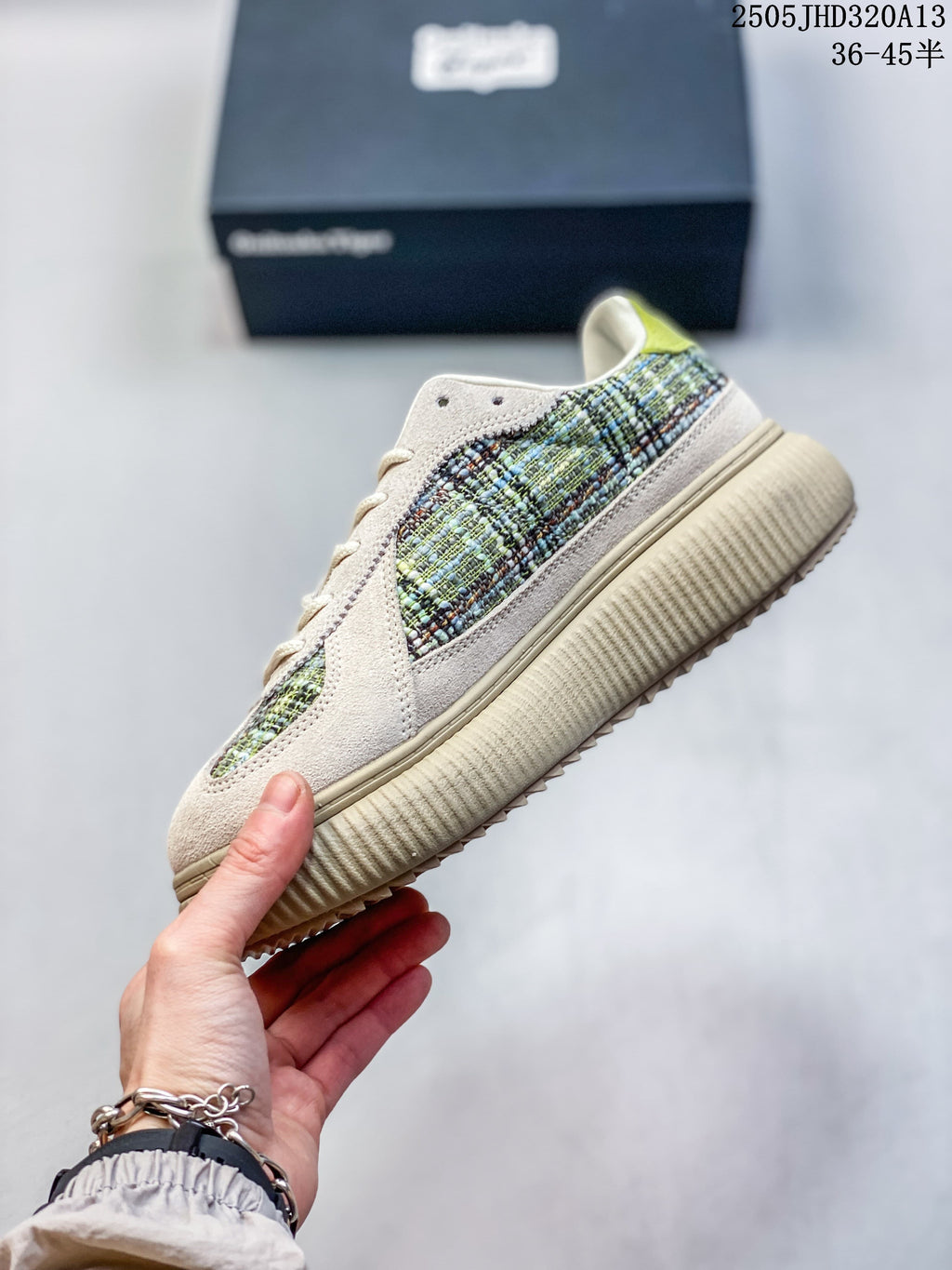 Side view of a light neutral low-top sneaker with multicolored woven-look panels