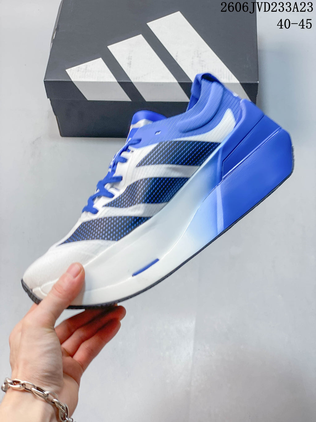 Side view of the white and blue running shoe with patterned panels.