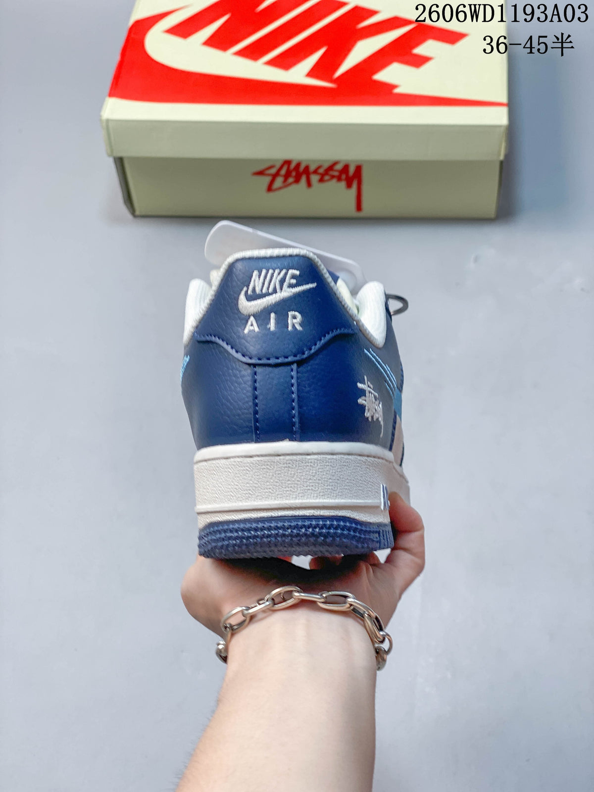Rear view of the sneaker with a blue heel panel and white midsole
