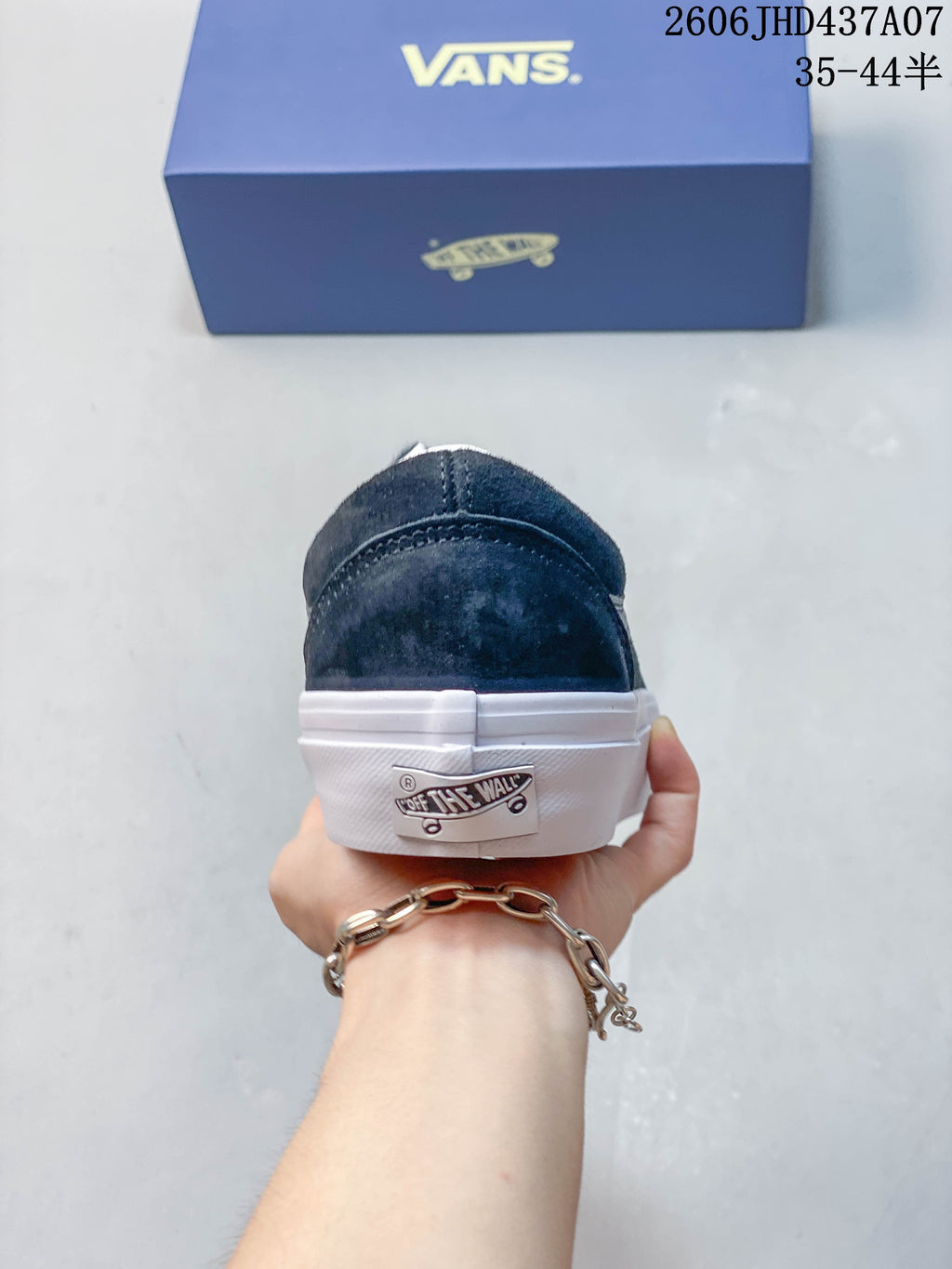 Rear view of a navy Vans sneaker showing the heel tab and white sole
