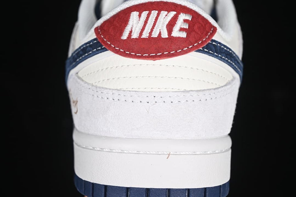 Rear view showing the red heel tab, navy detail, and white upper