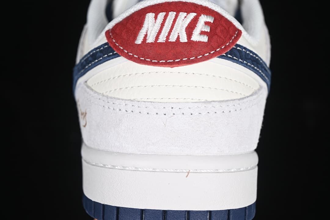 Rear view showing the red heel tab, navy detail, and white upper