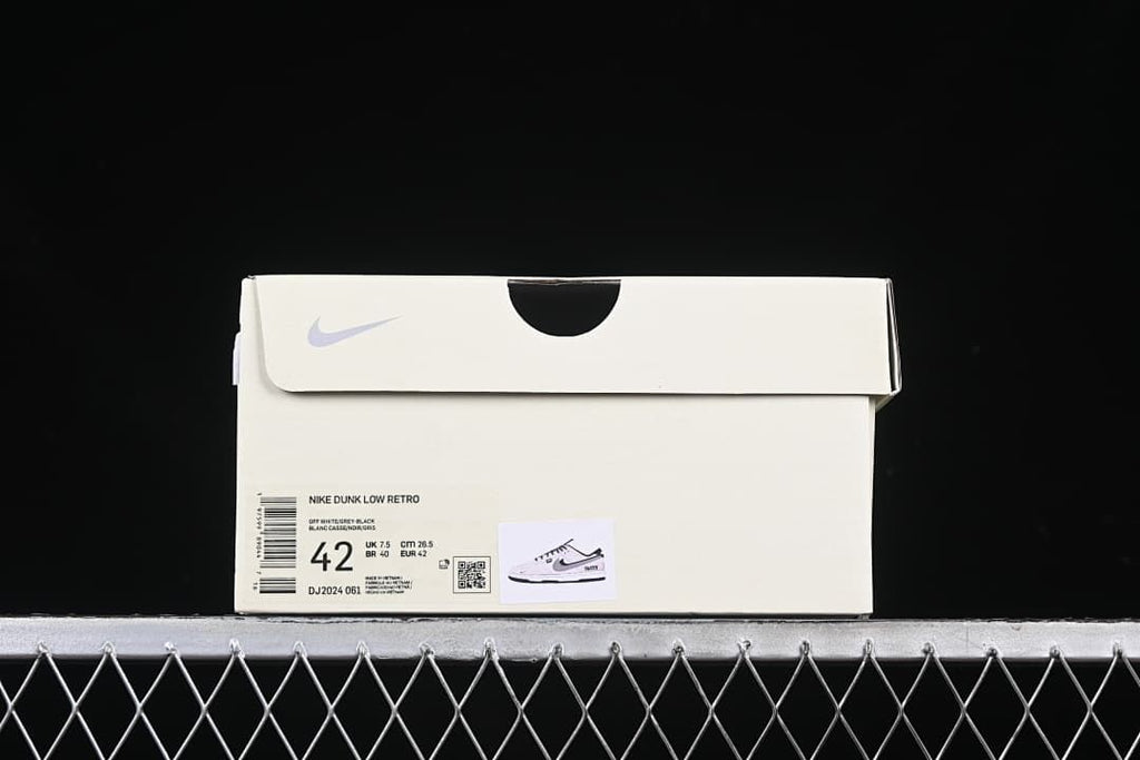 Sneaker box label showing Nike Dunk Low Retro, style code DJ2024 061, and EU 42