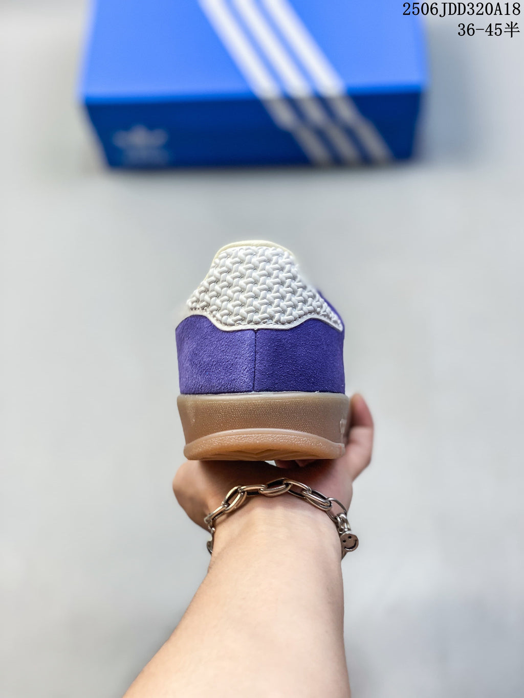 Rear view of the purple sneaker showing cream heel detail and gum-colored sole.