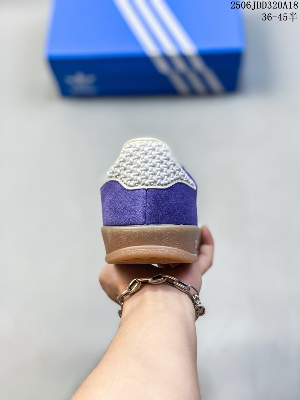 Rear view of the purple sneaker showing cream heel detail and gum-colored sole.