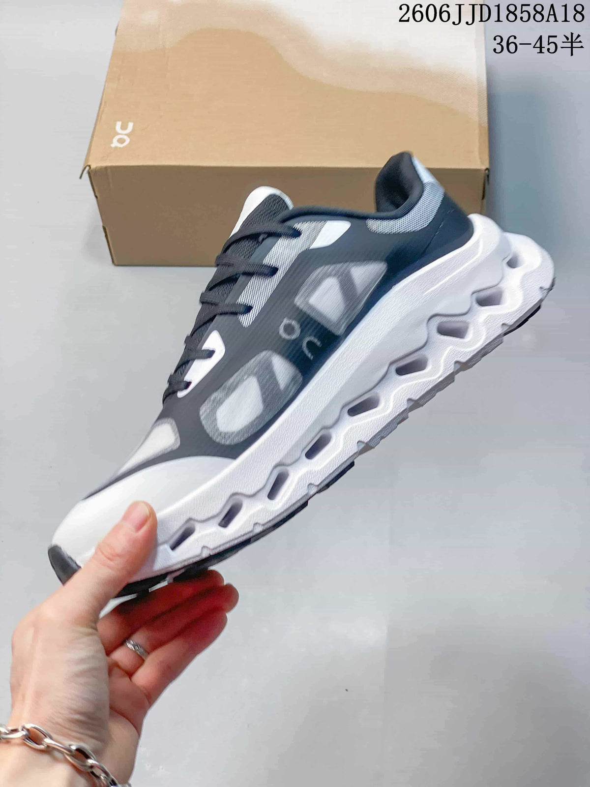 Side profile showing the grey and black upper and sculpted white sole.