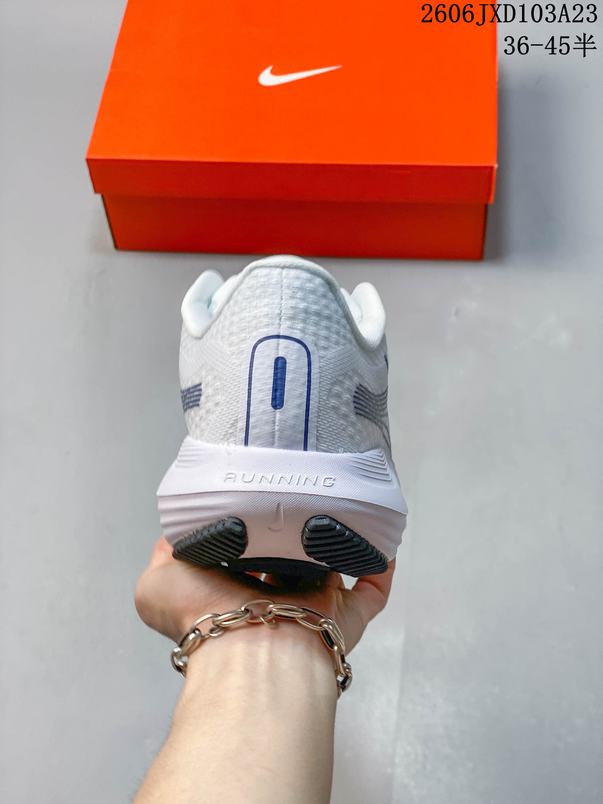 Rear view of the white running shoe showing heel details and outsole