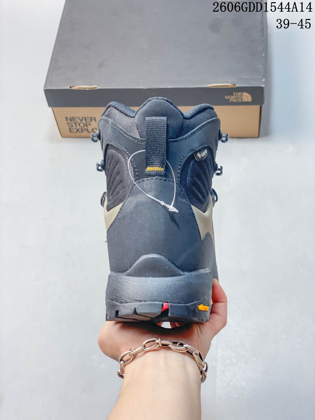 Rear view of a Verto Alpine high-top hiking boot with a padded collar and lugged sole.