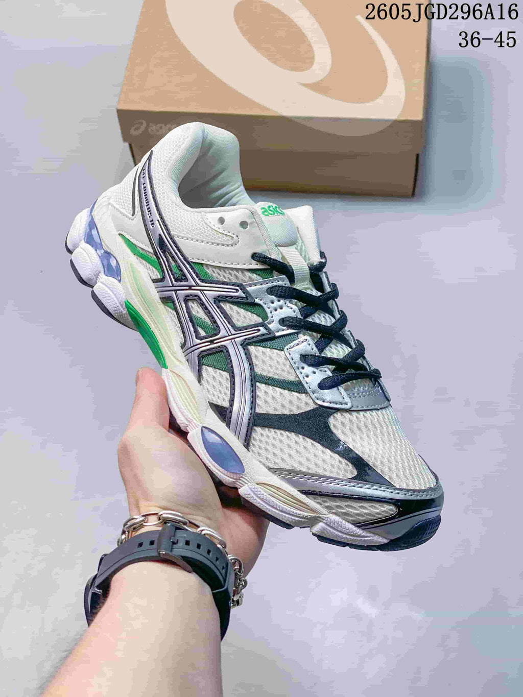 White ASICS Gel-Cumulus 16 sneaker with green and dark navy accents.