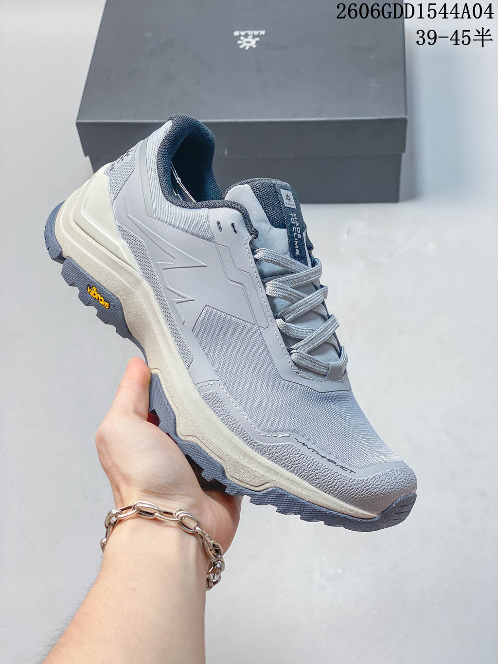 Angled side view of a light grey KAILAS hiking shoe with a lugged outsole.